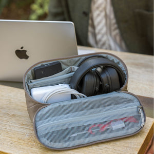 Portable CIVIC Access Pouch 2L in Fossil Brown with headphones and other items on a wooden surface