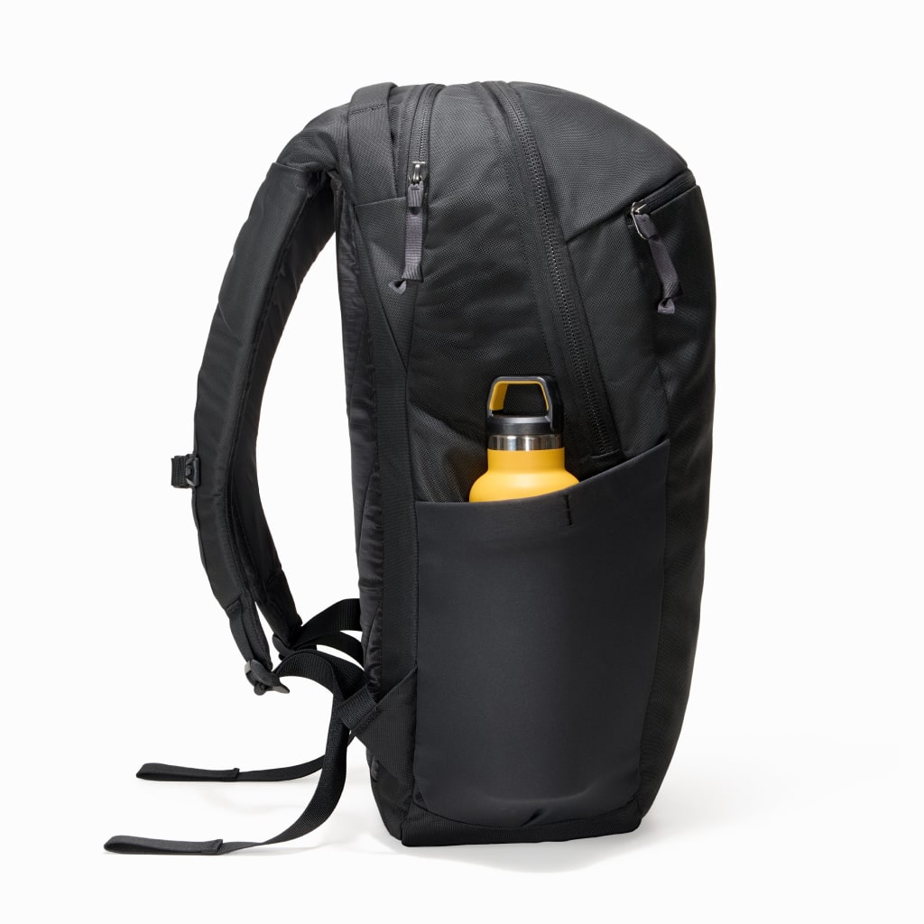 CIVIC Half Zip 26l in Solution Dyed Black - side view with water bottle CIVIC Half Zip 26l in Solution Dyed Black - side view with water bottle [13005d-SBK