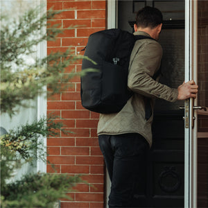 CIVIC Half Zip 26l in Solution Dyed Black - worn while commuting