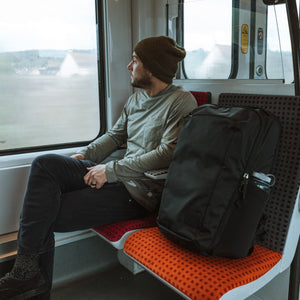 CIVIC Travel Bag 35L in solution dyed black in paris on train