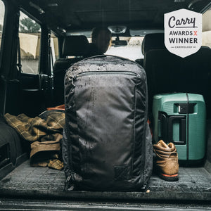 CIVIC Travel Bag 35L in solution dyed black back of truck