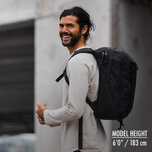 CIVIC Travel Bag 20L in solution dyed black on a 6'0" model