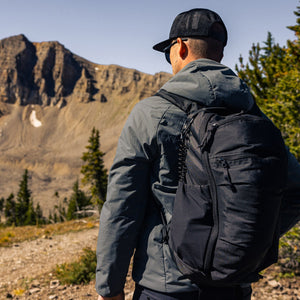 Mountain Panel Loader 22L in Solution Dyed Black, outside on hike