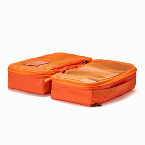 Transit Packing Cube 8L in Hot Orange open and flat on table