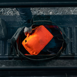 Transit Packing Cube 8L in Hot Orange on the road