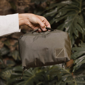 Transit Packing Cube 8L in OD Green - held by the top handle webbing