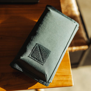 CIVIC Access Pouch 1L in Dark Navy Konbu - closed on a desk