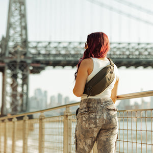 CIVIC Access Sling 2L - CAS2 in OD Green - person wearing sling along boardwalk