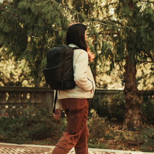 CIVIC Bookbag 22L CB22 in Solution Dyed Black - side view walking through campus