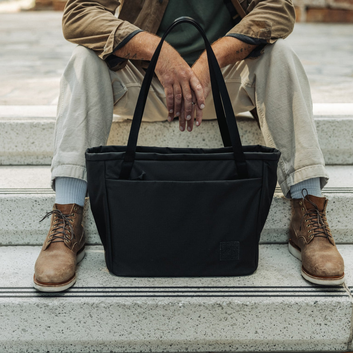 CIVIC Daily Tote 24L in Solution Dyed Black - CDT24 - sitting on steps