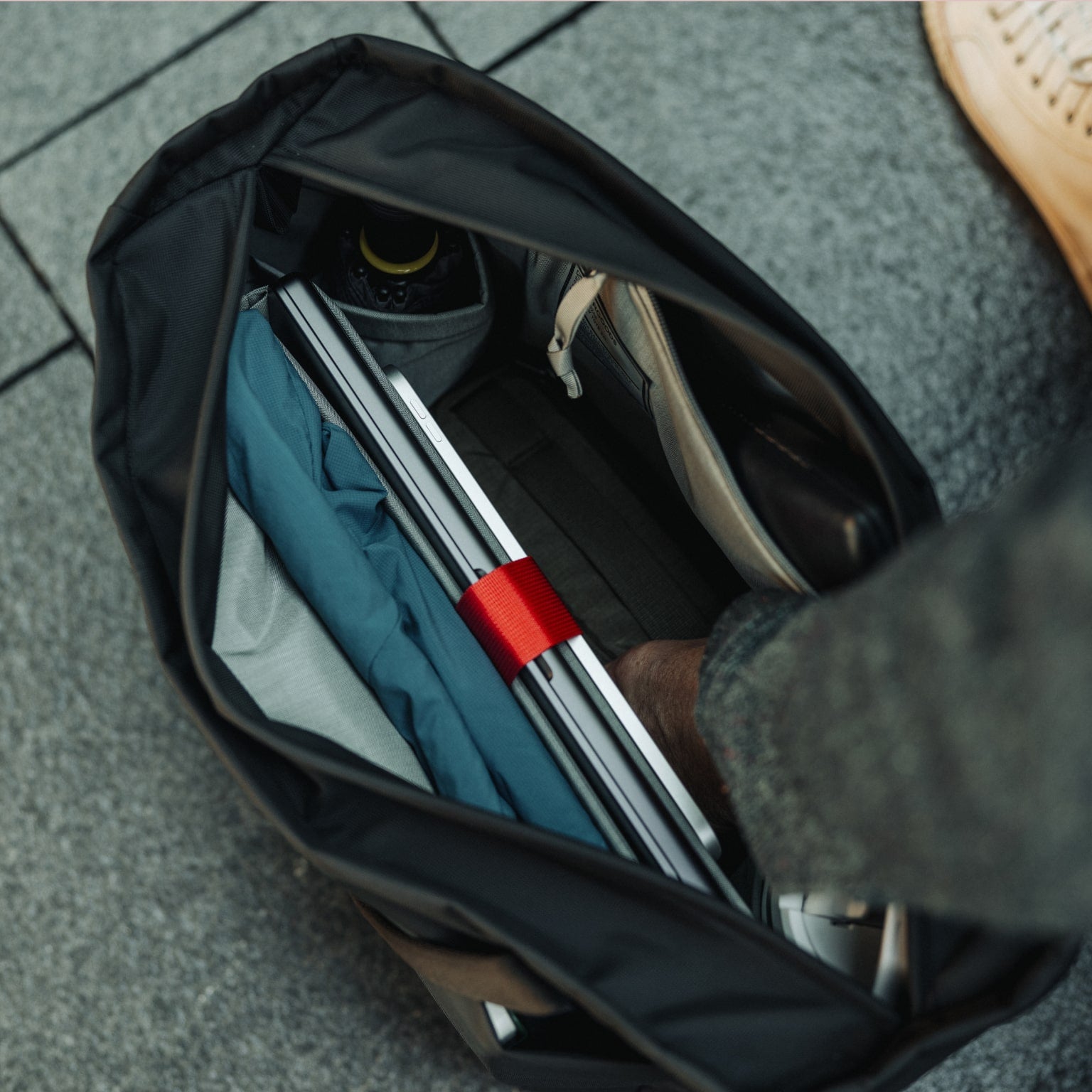 CIVIC Daily Tote 24L in Solution Dyed Black - CDT24 - wide opening, reaching in to grab CAP2 [13024a-SBK]