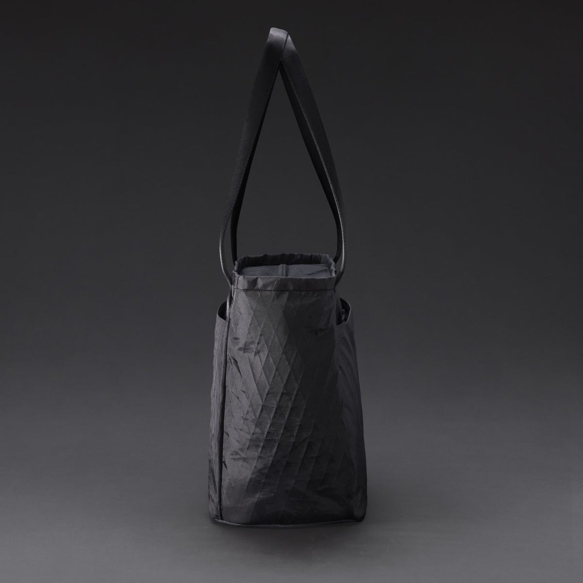 CIVIC Daily Tote 24L in X-Pac Black and Coyote Brown - side profile with magnetic handles