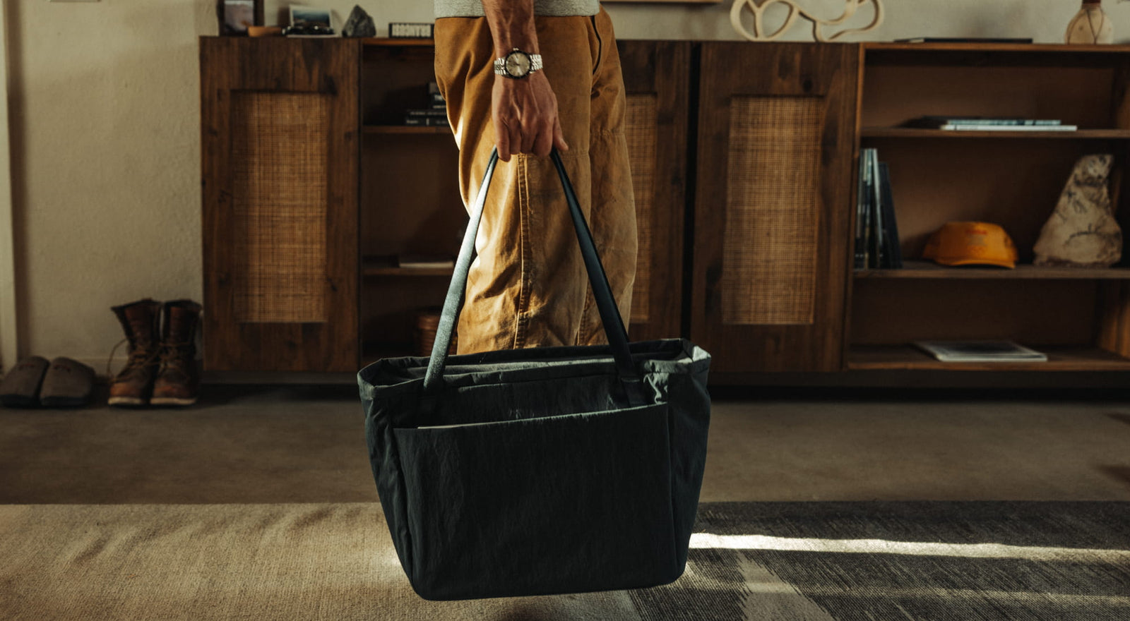 The Konbu Capsule in Dark Navy - CIVIC Daily Tote 24L held by straps