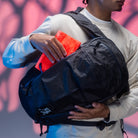 CIVIC Flat Pouch - CFP - in Electric Coral - Stowed in front side-access pocket of backpack
