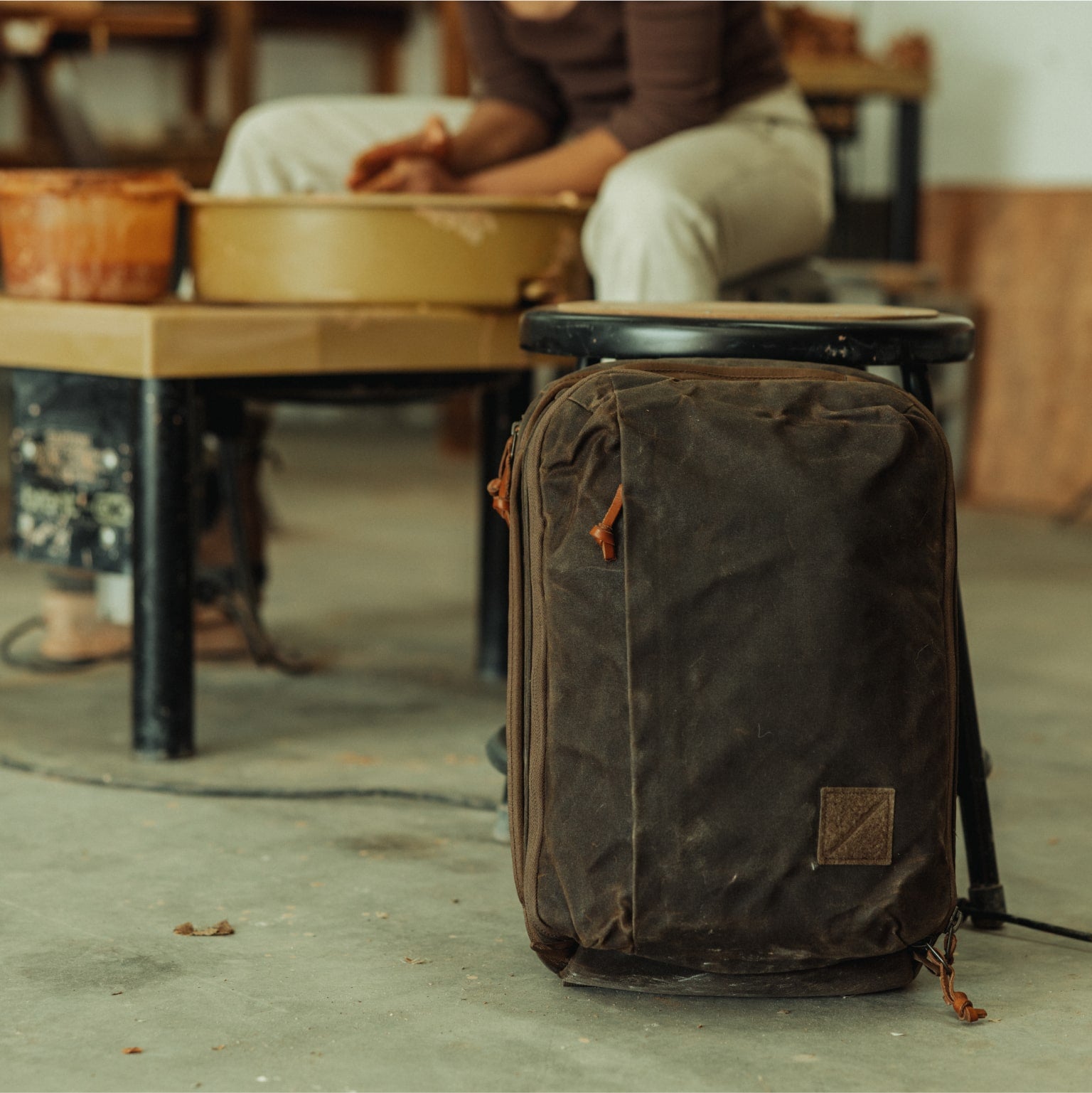 Waxed canvas CIVIC Panel Loader 16L in studio garage setting