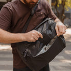 Man holding a black CIVIC Travel Bag 26L outdoors Man holding a black CIVIC Travel Bag 26L outdoors [13012c-SBK