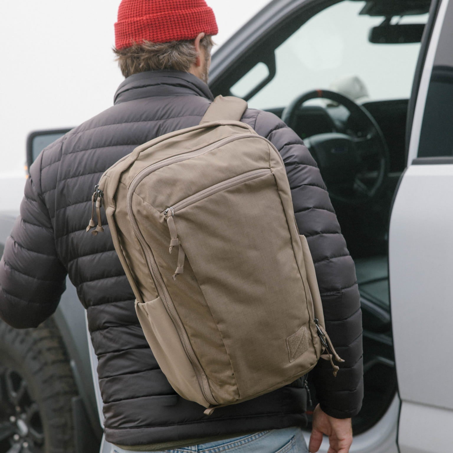 Person with a Fossil Brown CIVIC Travel Bag 20L backpack getting into a vehicle [13019c-FBN]