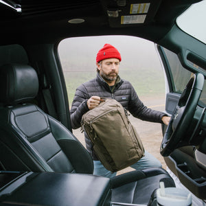 CIVIC Travel Bag 20L in Fossil Brown - top handle going into truck - roadtrip