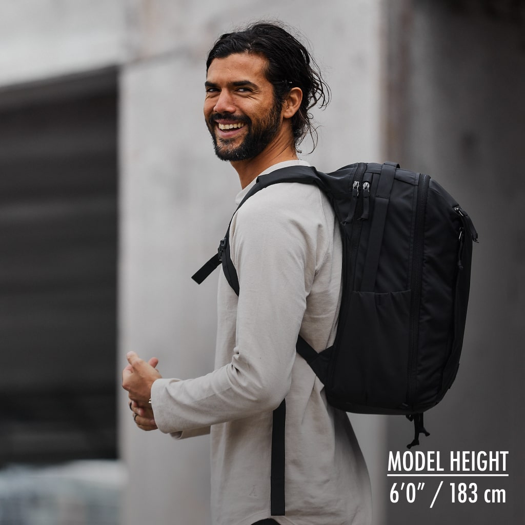 CIVIC Travel Bag 20L in solution dyed black on a 6'0" model