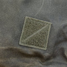 Textured green patch on a olive fabric background Textured green patch on a olive fabric background [13019cc-WOL, 13012cc-WOL