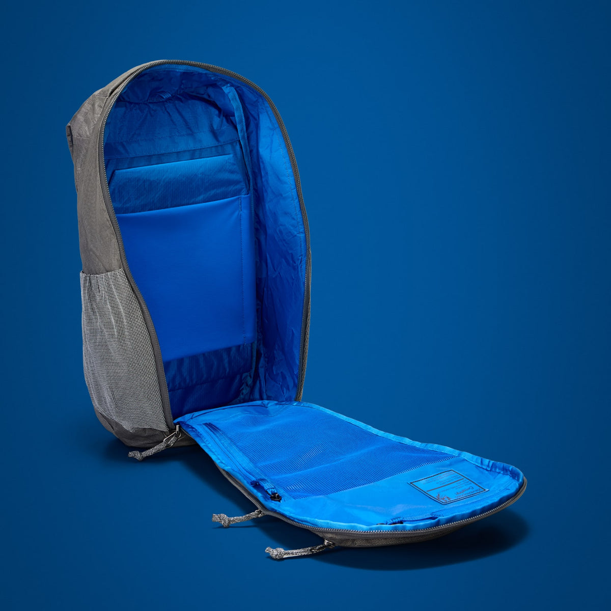 MOUNTAIN Panel Loader 22L in Gravel Gray - Ultra - Blue Flame lining shown in panel loading clamshell opening