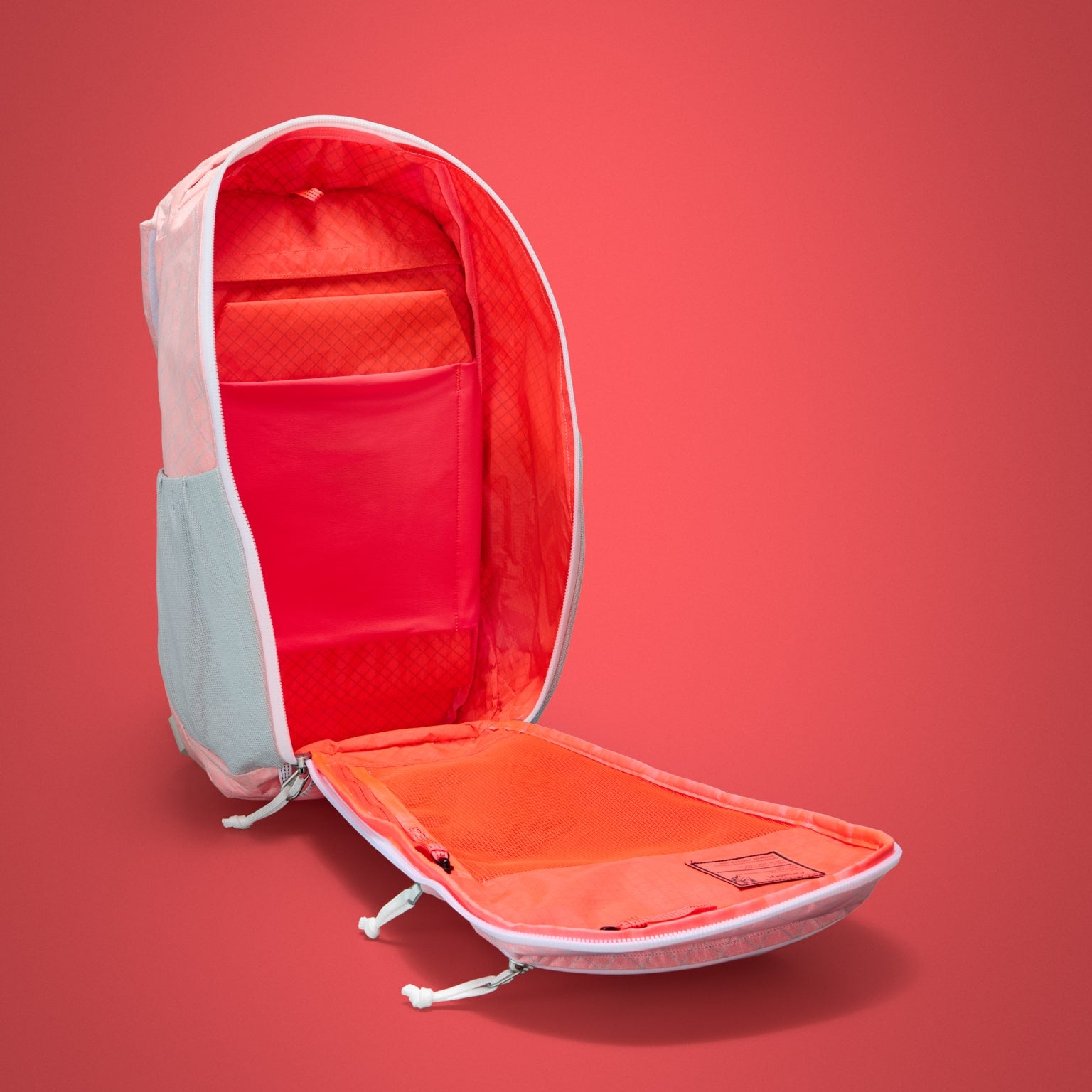 MOUNTAIN Panel Loader 22L in Arctic Kludde - Ultra - Electric Coral lining shown with panel loading