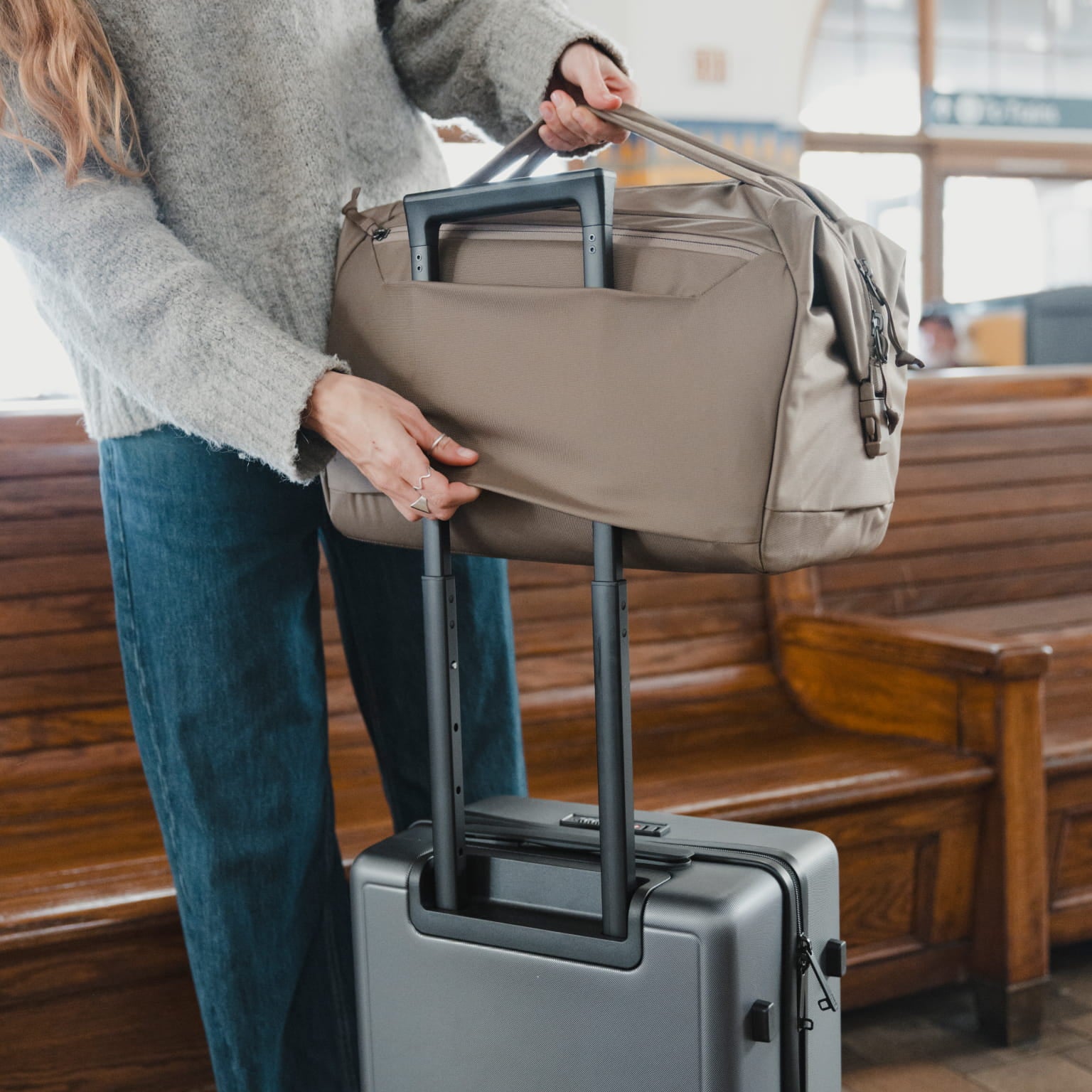 Transit Duffel 25L in Fossil Brown - luggage pass through in use