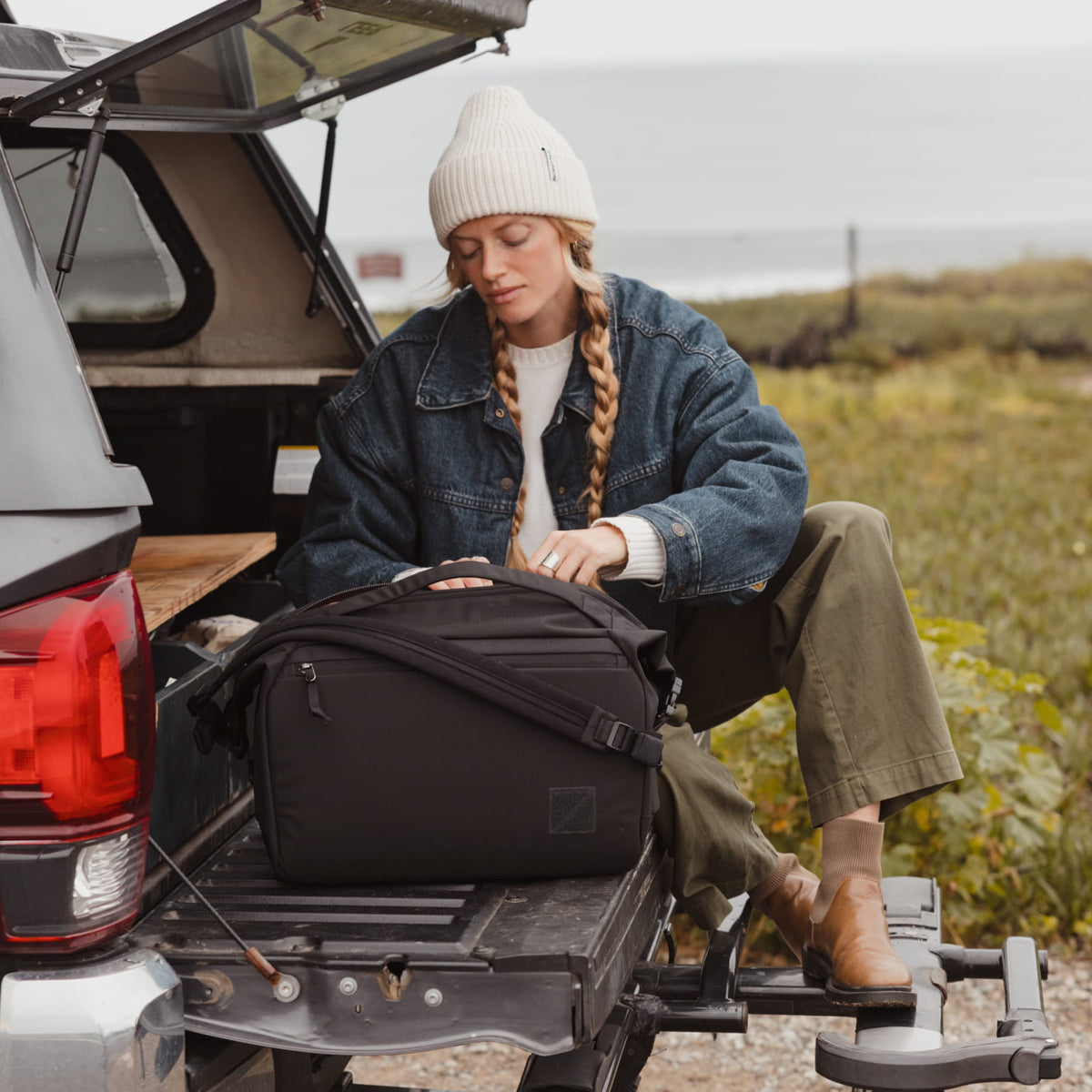 Transit Duffel 25L in Solution Dyed Black - back of truck for road trip