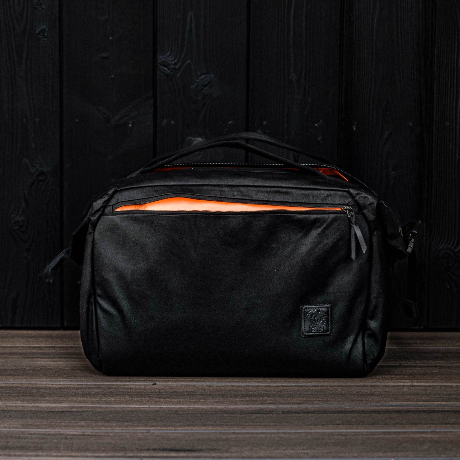 Transit Duffel 35L Waxed Black Carryology Hot Orange Hi Vis Interior
