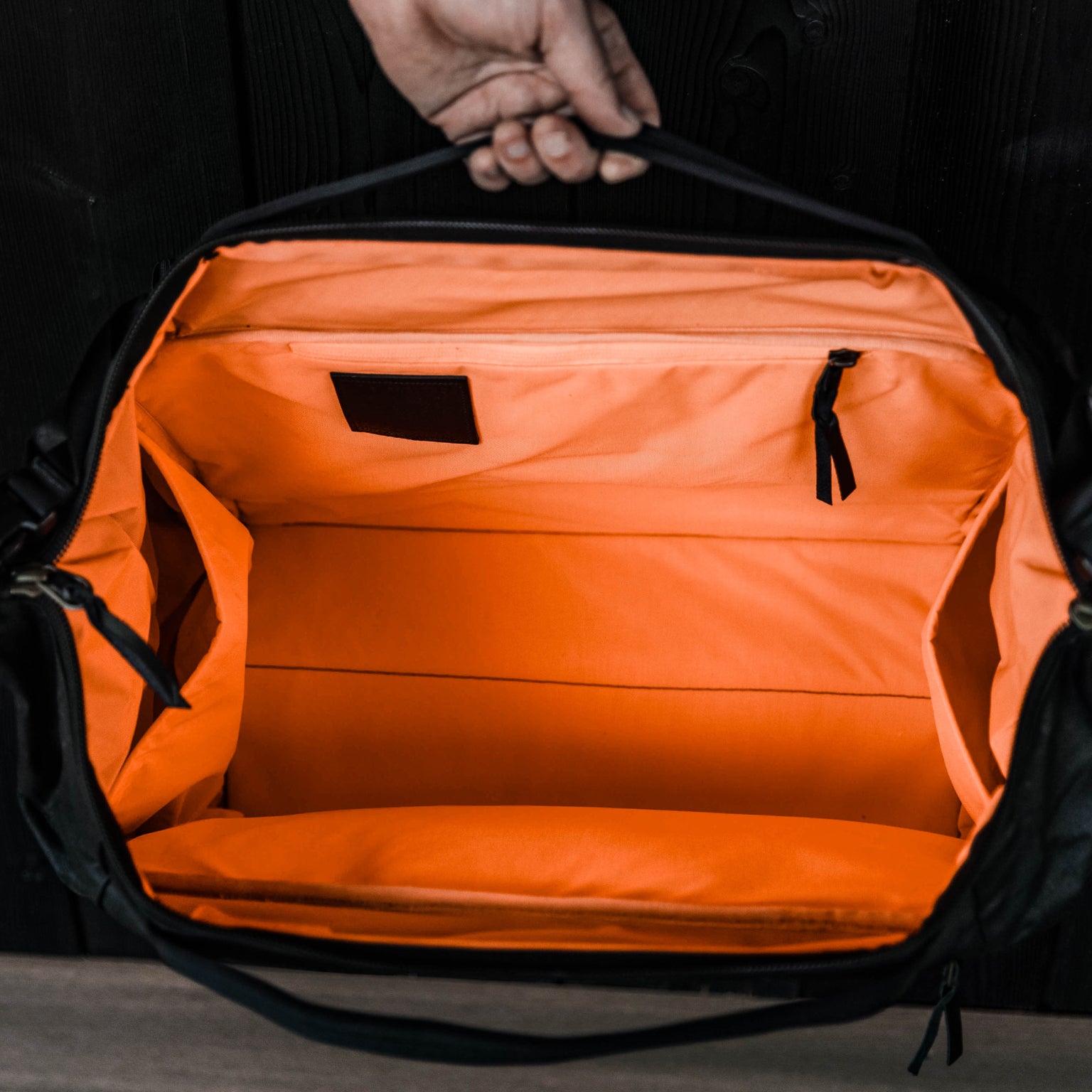 Transit Duffel 35L Waxed Black Carryology Hot Orange Hi Vis Interior