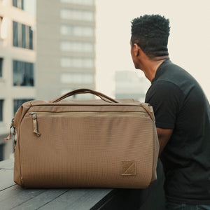 Transit Duffel 35L in Coyote Brown outside at hotel