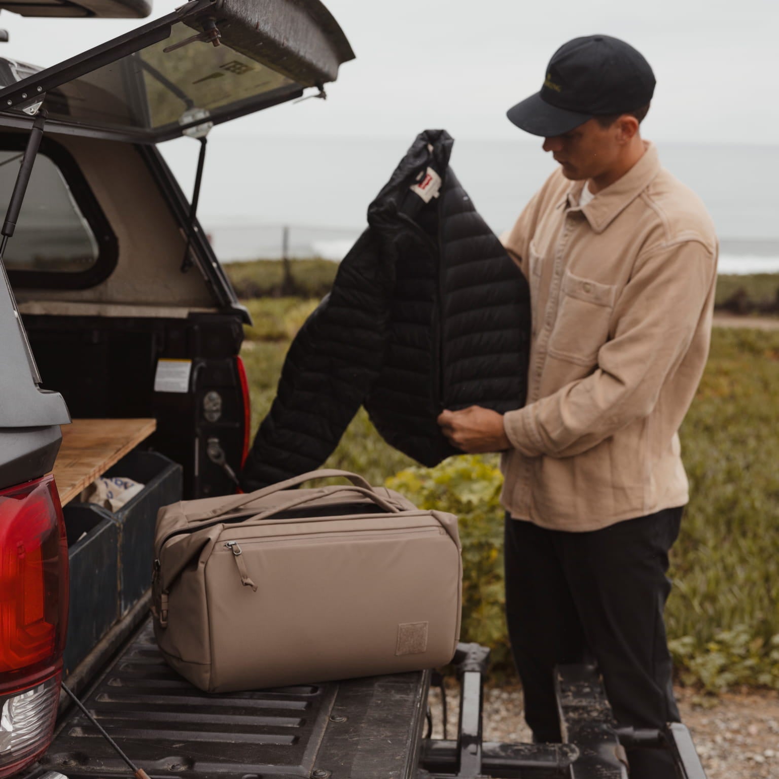 Transit Duffel 35L in Fossil Brown back of truck [13014d-FBN]