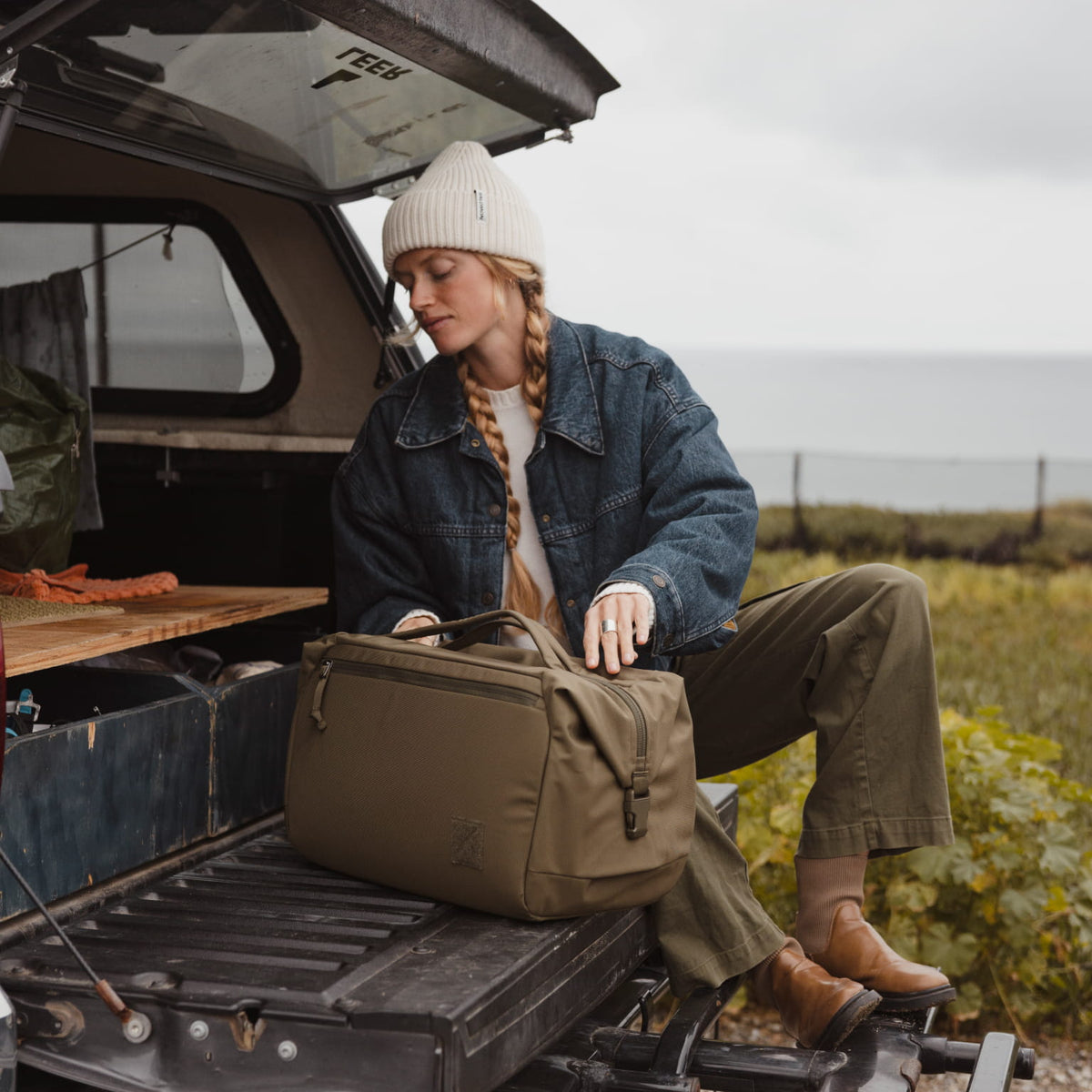 Transit Duffel 35L in OD Green used on the back of a truck road trip