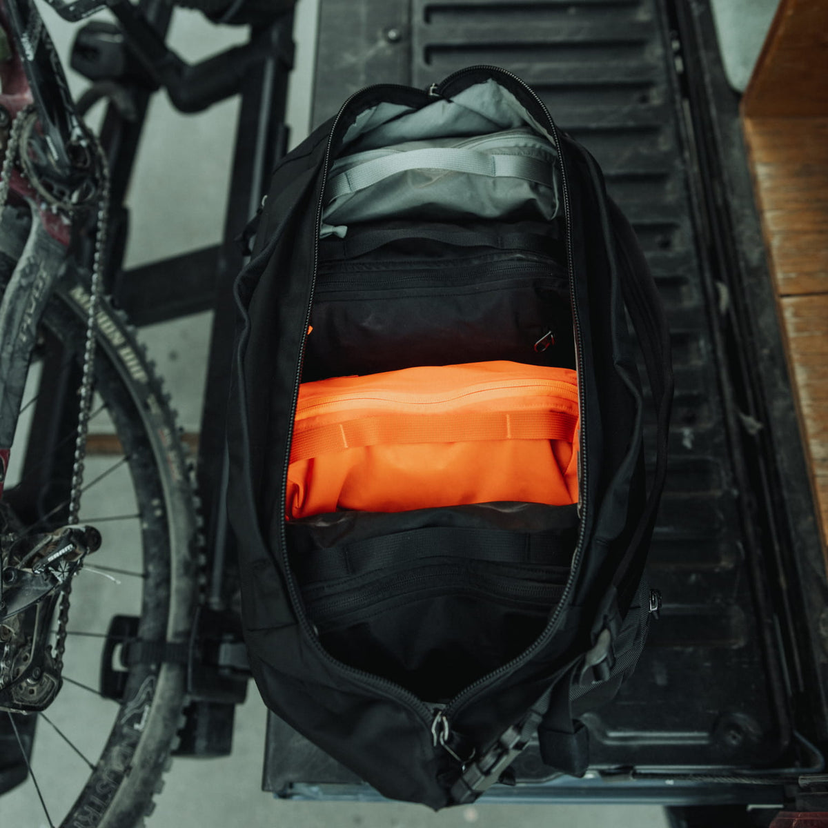 Transit Duffel 35L in Solution Dyed Black - on back of truck with TPC10s