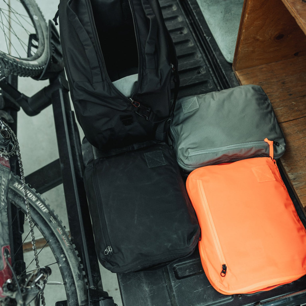 Transit Packing Cube 10L in Black, Hot Orange, and Standard Gray