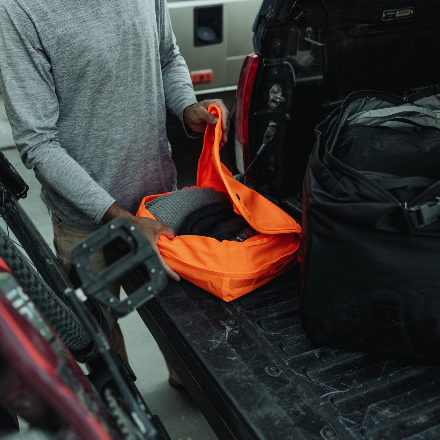 Transit Packing Cube 10L in Hot Orange - opening and packed with clothes [13021a-HTO]