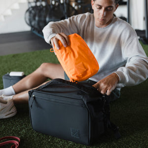 Transit Packing Cube 4L in Hot Orange - packed into Transit Duffel 25L