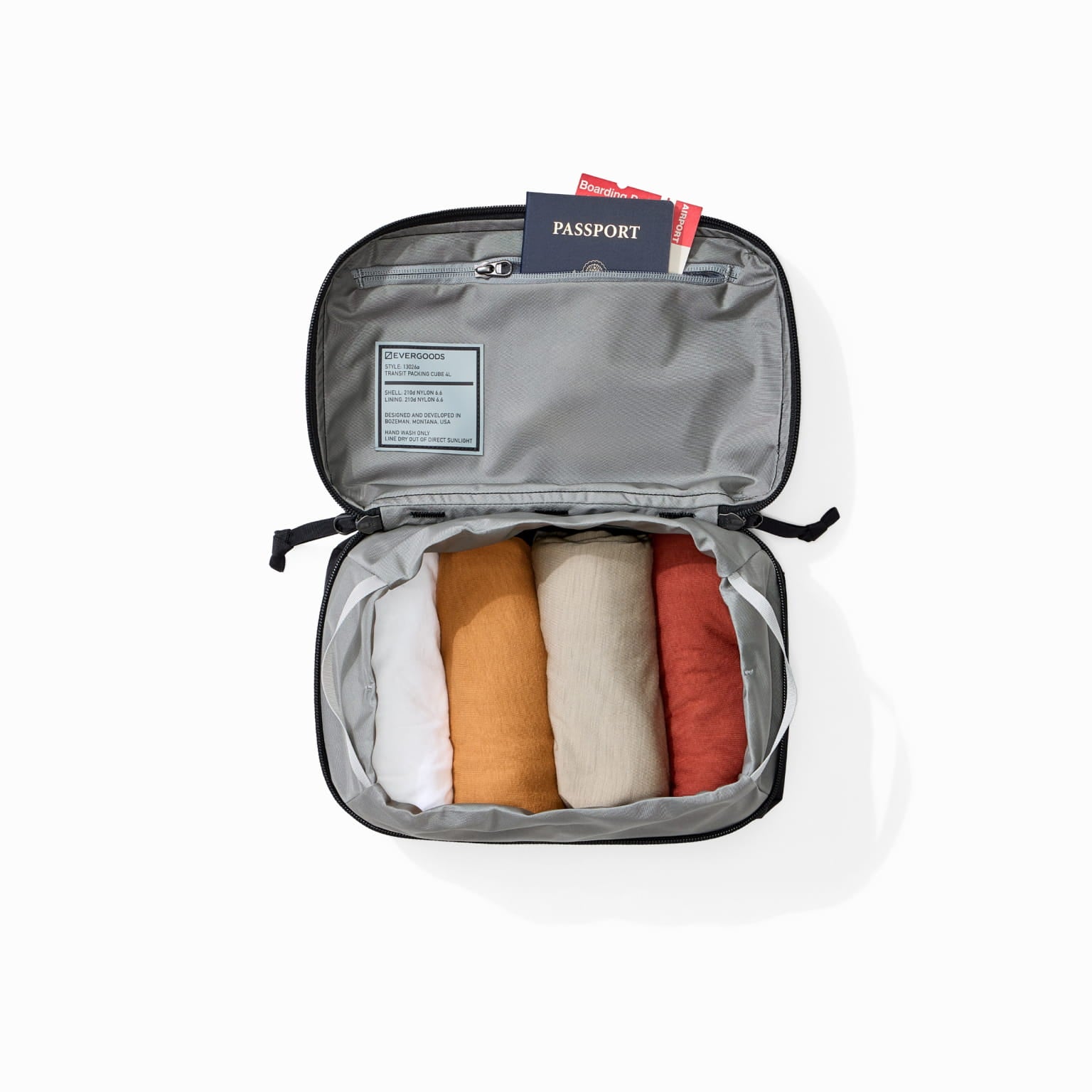 Transit Packing Cube 4L in Black - open and packed with travel documents [13026a-BLK]