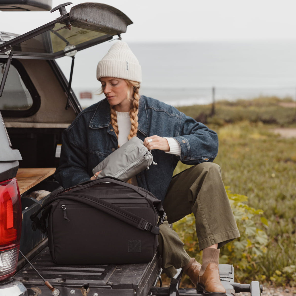 Transit Packing Cube 4L in Standard Gray - being packed into transit duffel 25L