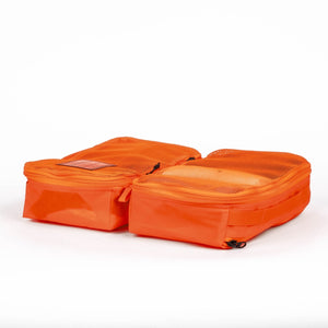 Transit Packing Cube 8L in Hot Orange open and flat on table