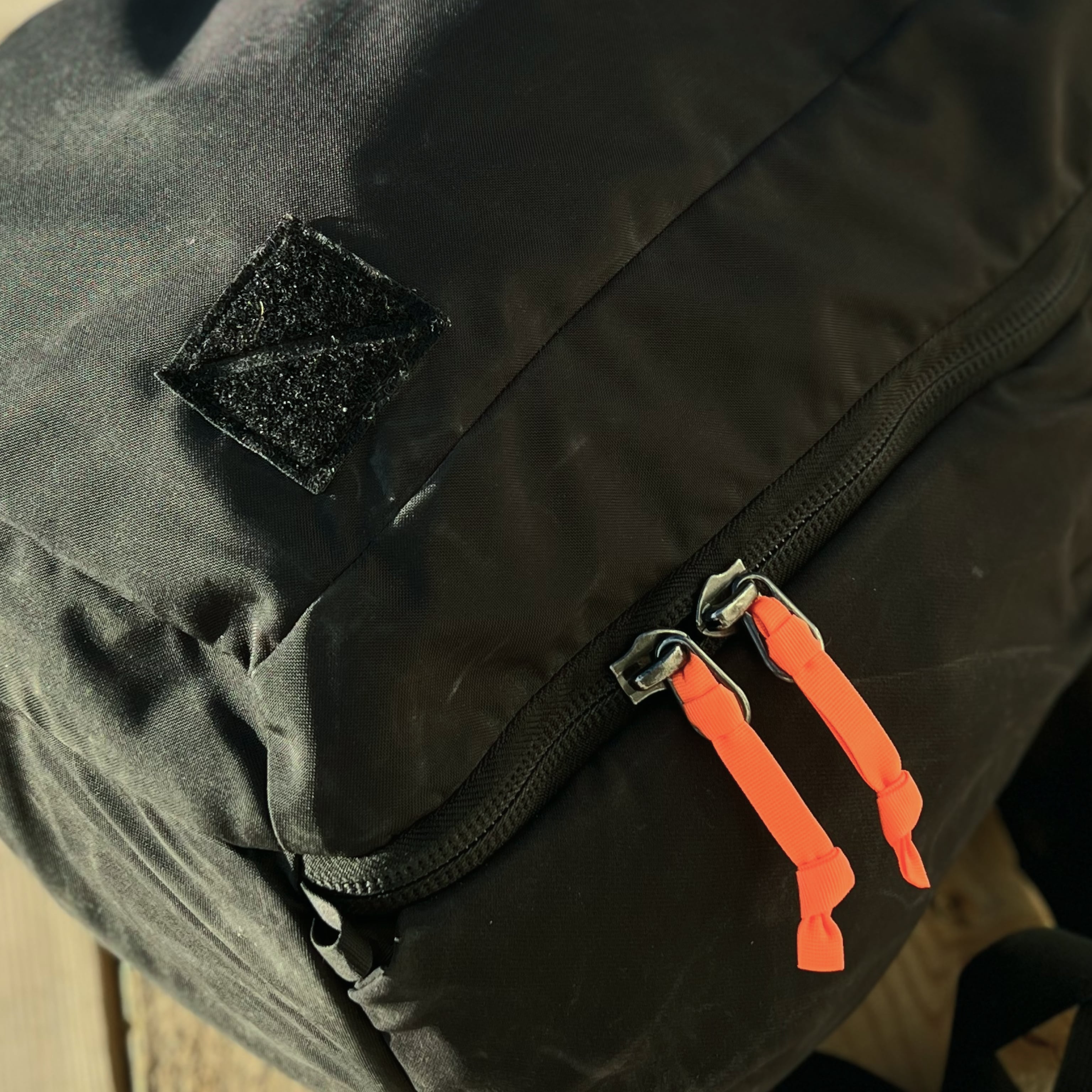 EVERGOODS Hot Orange Webbing Zipper Pullers on Black Backpack [19004a-HTO]